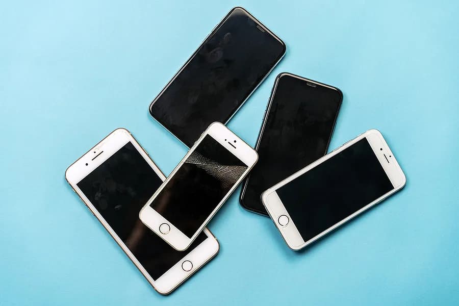 D'anciens iPhone sur fond bleu